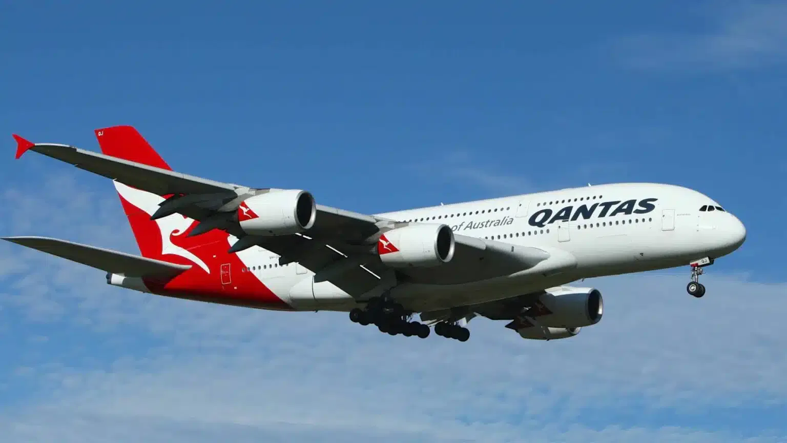 A Qantas plane soaring through the air promoting wellness.