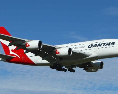 A Qantas plane soaring through the air promoting wellness.